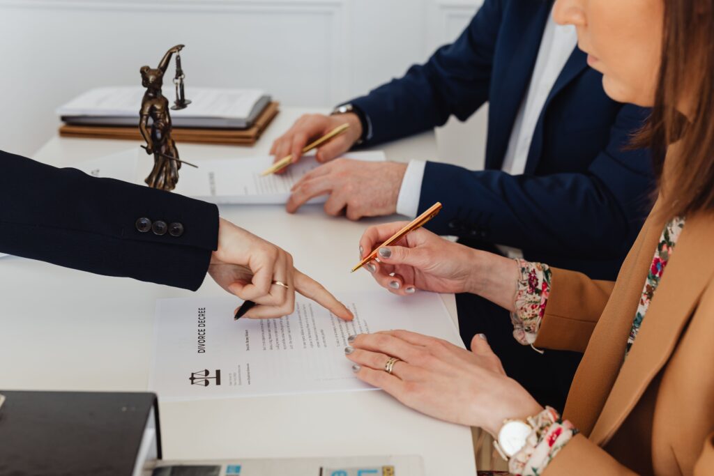 a picture of a couple finalizing divorce agreements guided by a family lawyer